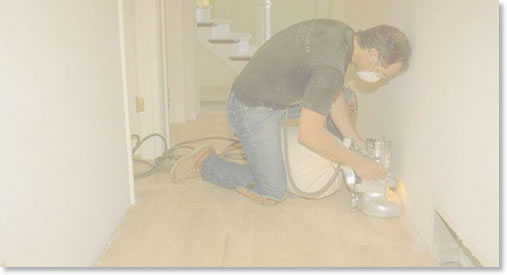 Man with powersaw cutting flooring